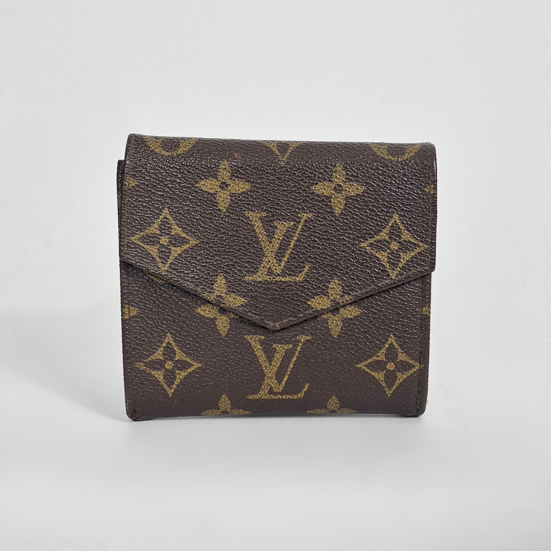 Louis Vuitton wallet with monogram pattern on a light gray background