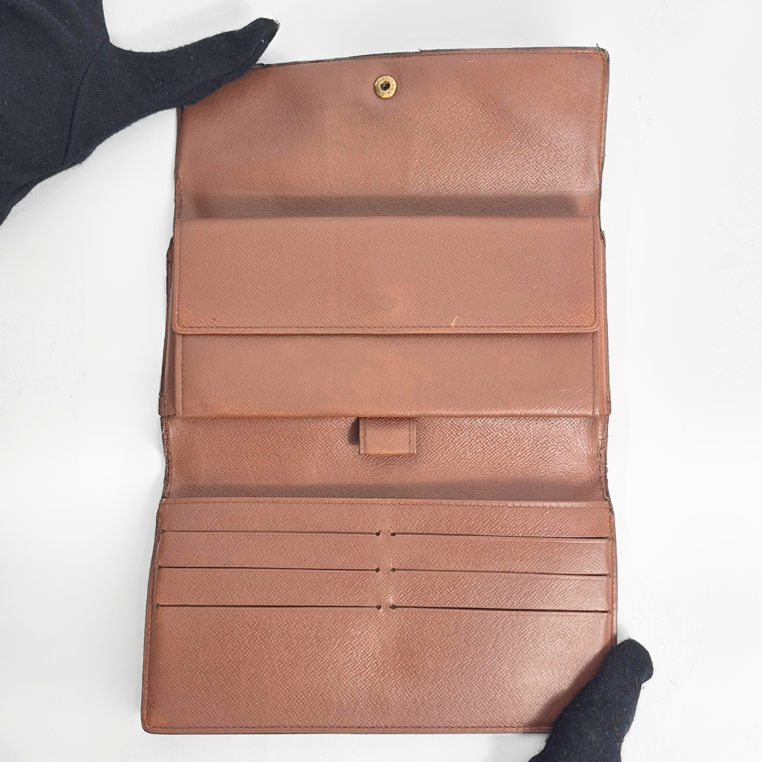 Brown leather wallet with multiple card slots on a white background