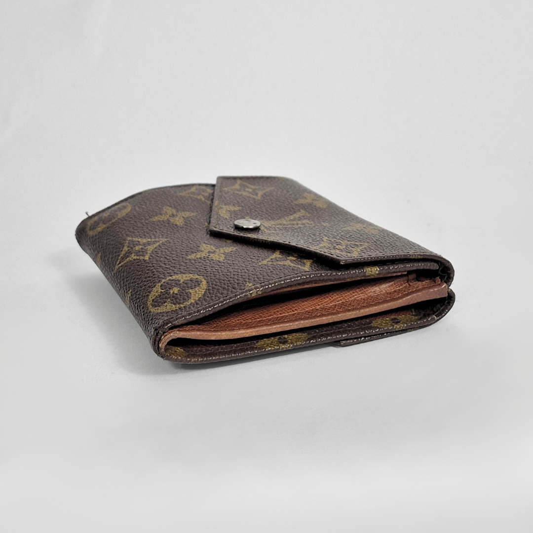 Brown monogrammed wallet on a light gray background