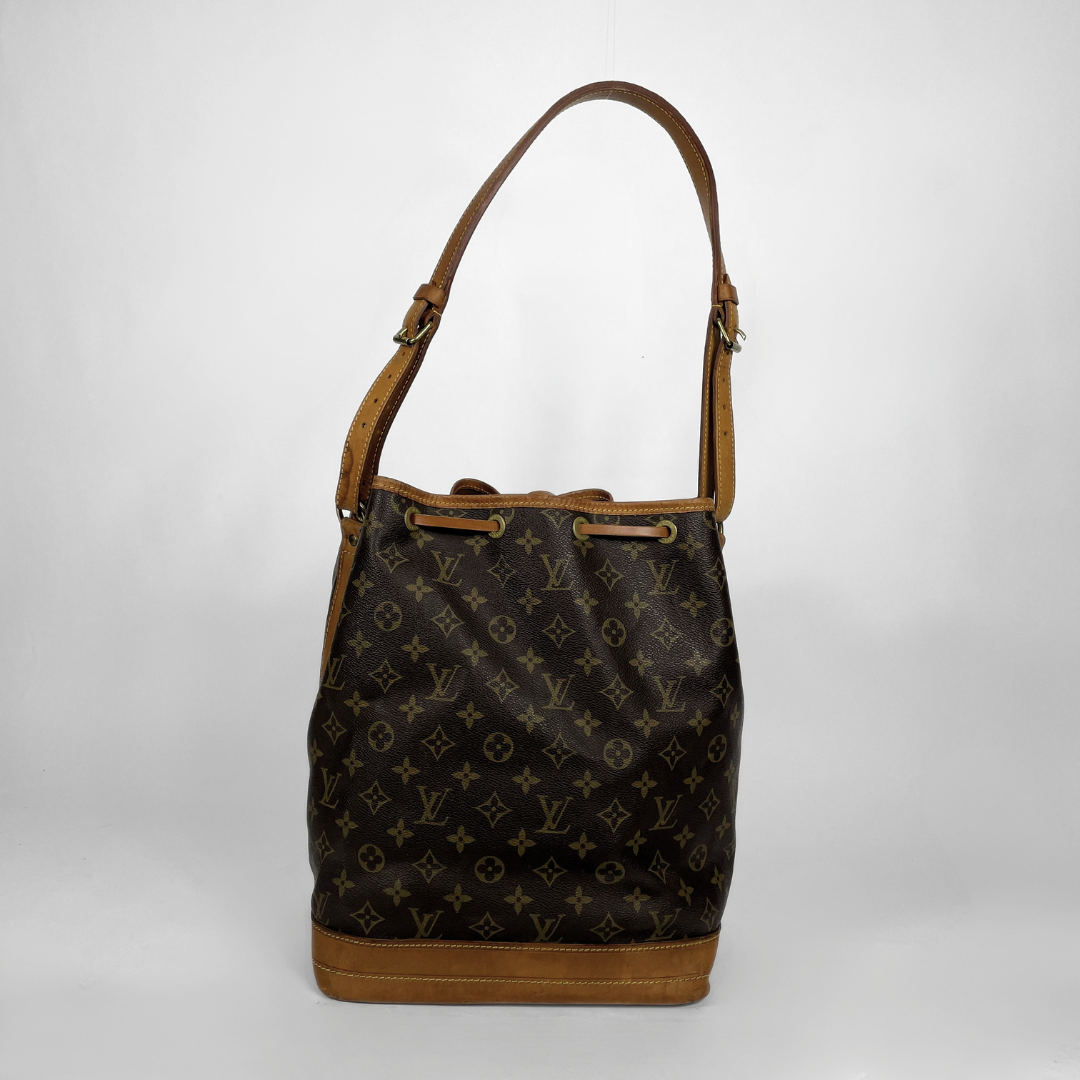 Louis Vuitton monogram canvas shoulder bag with tan leather trim and strap, shown against a light gray studio background.
