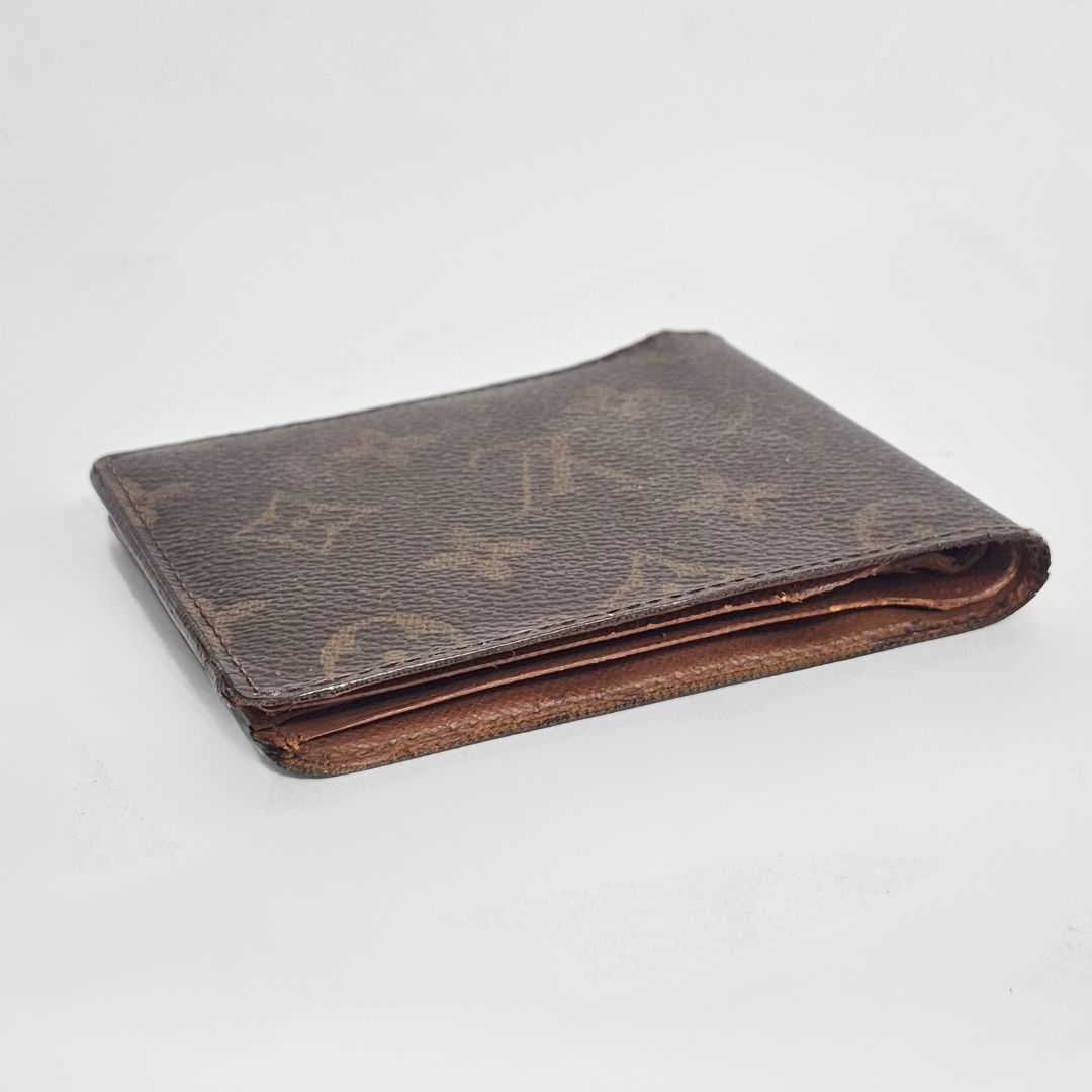 Brown leather wallet on a light gray background