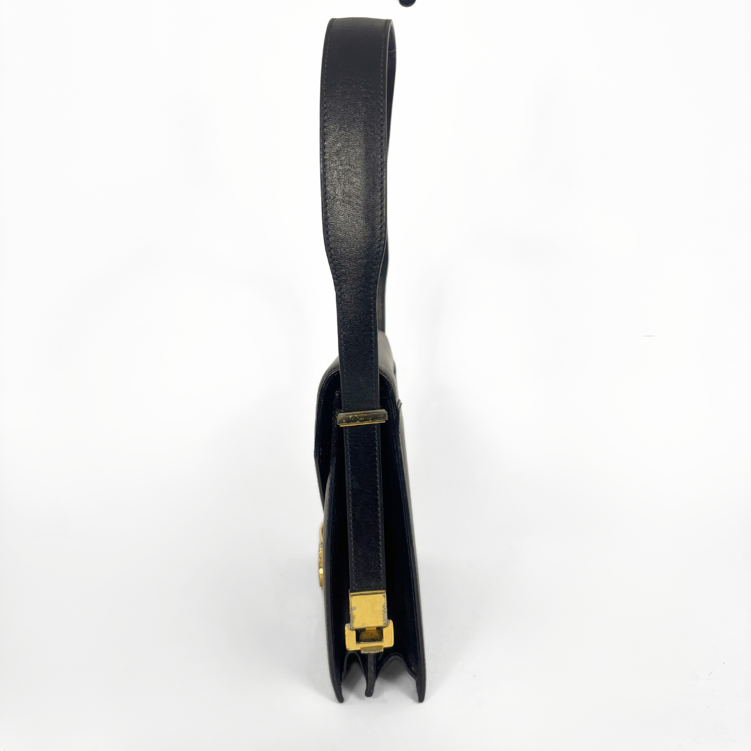 Celine vintage black leather shoulder bag with gold-tone horse and cariage buckle.
