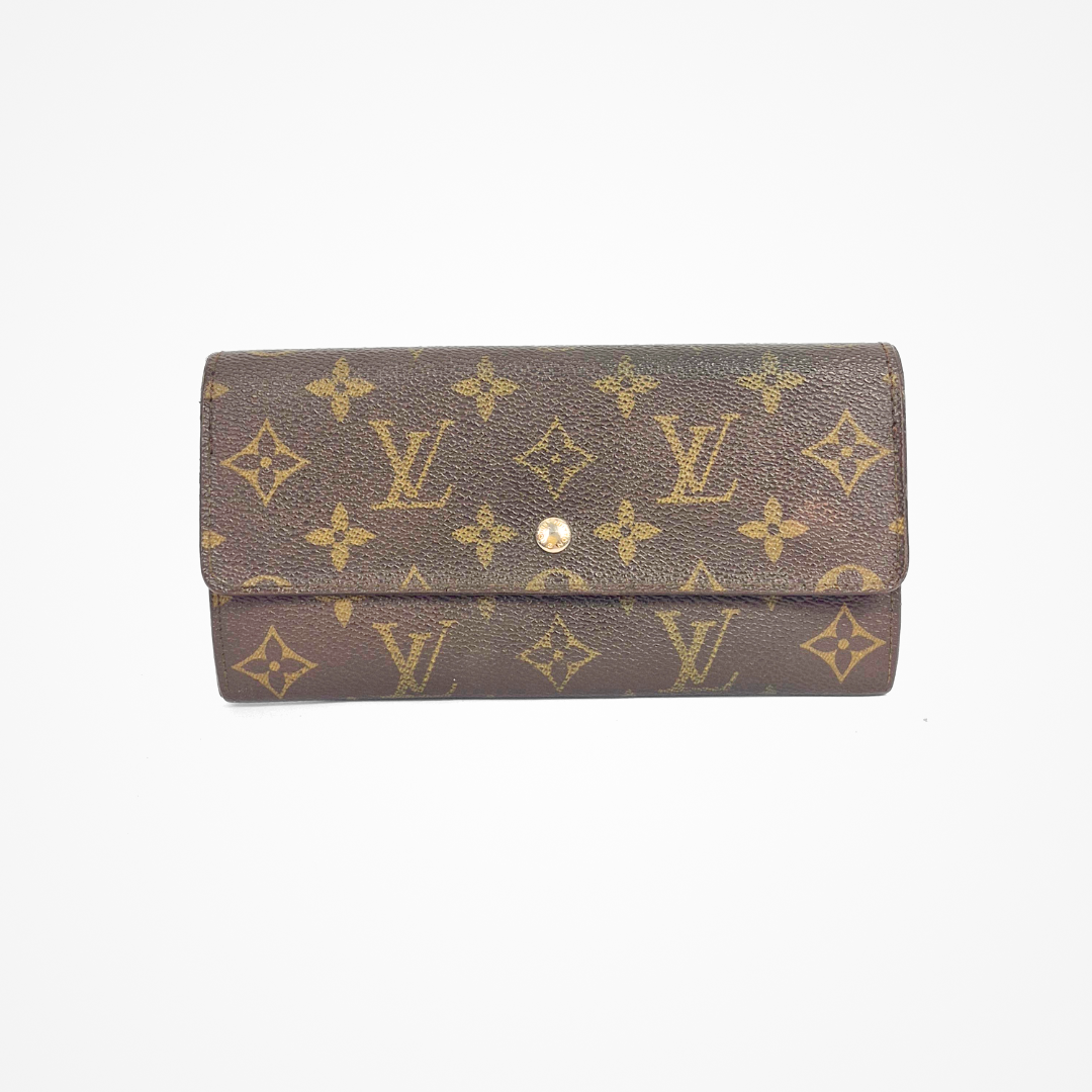 Brown LV wallet with gold monogram pattern on a white background