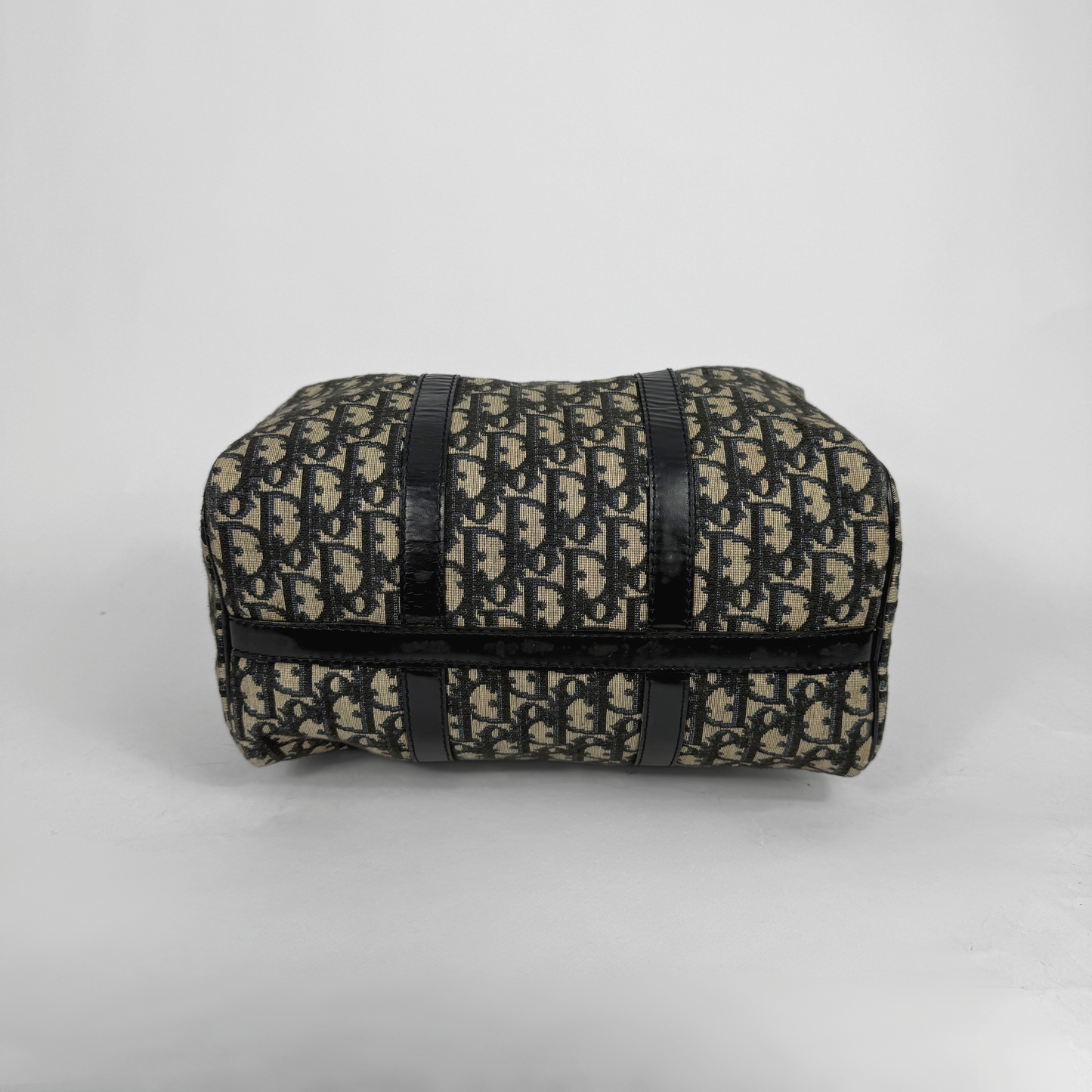 Patterned pouch with black straps on a light gray background