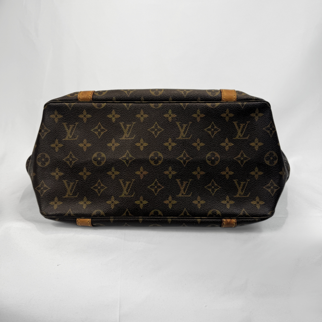 Louis Vuitton monogram canvas shoulder bag in dark brown with tan leather trim, photographed from the back on a white background.