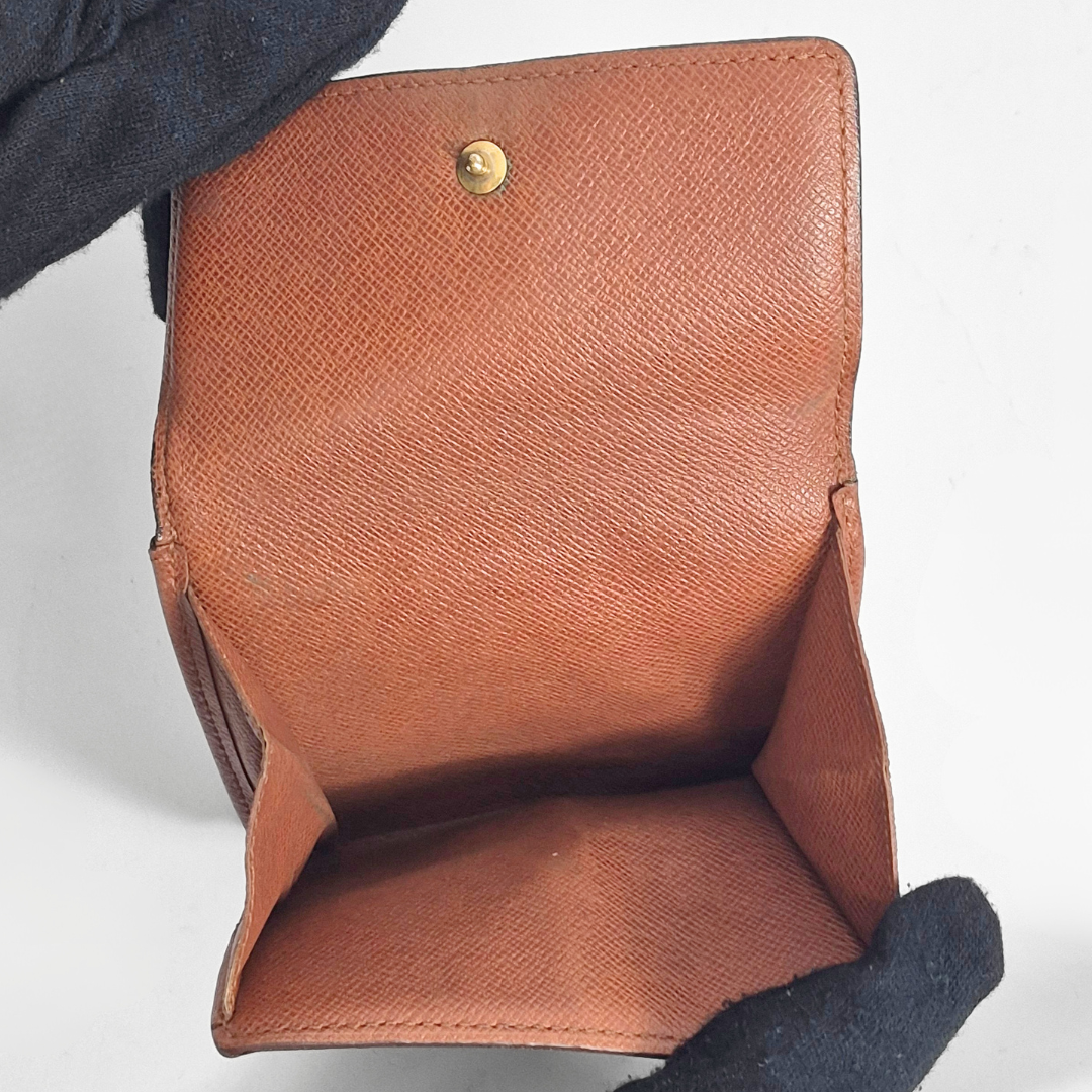 Brown leather wallet with gold button on a white background