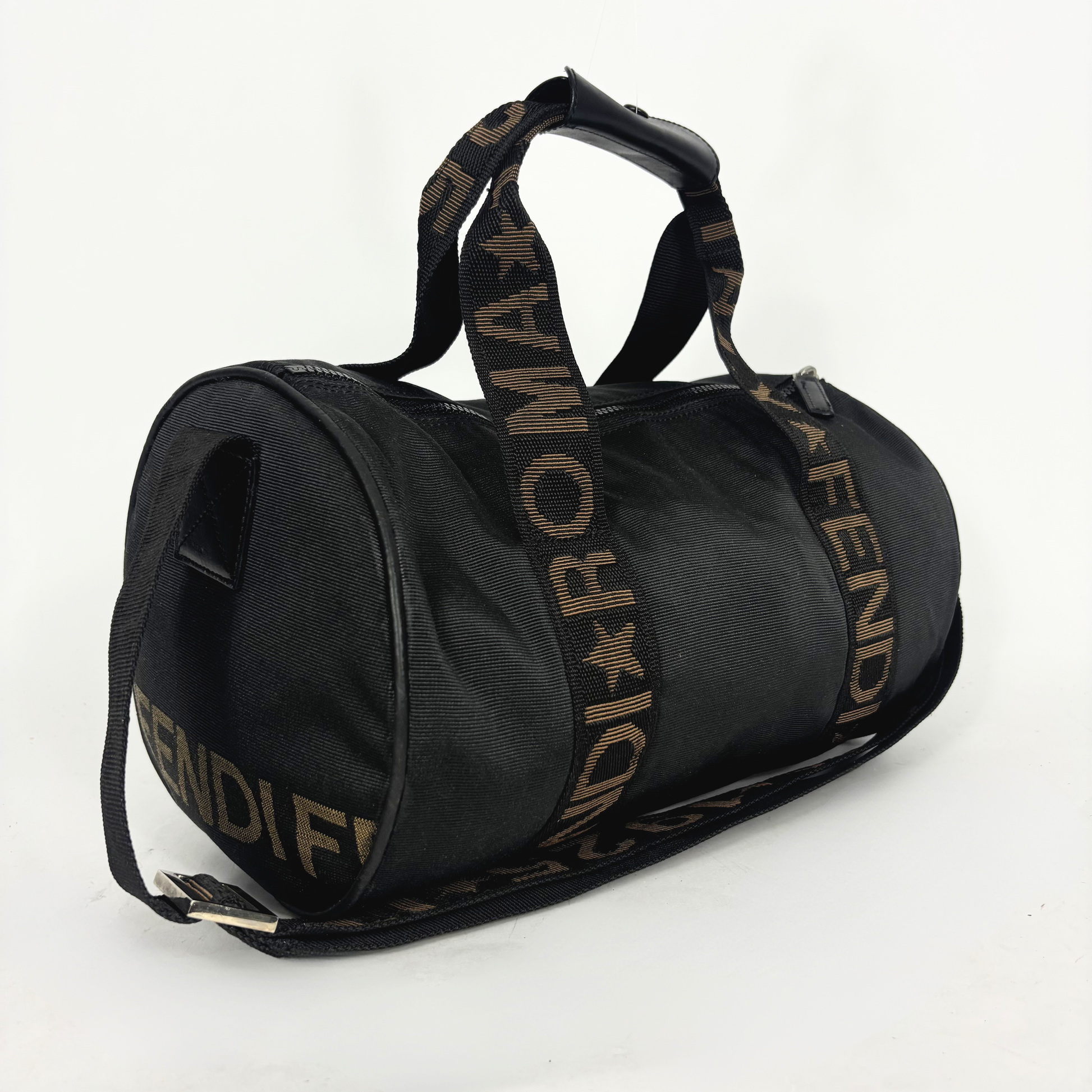 Black duffel bag with gold Fendi branding on a white background