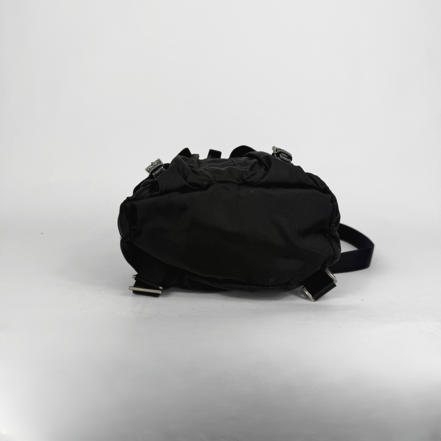 Black backpack on a light gray background
