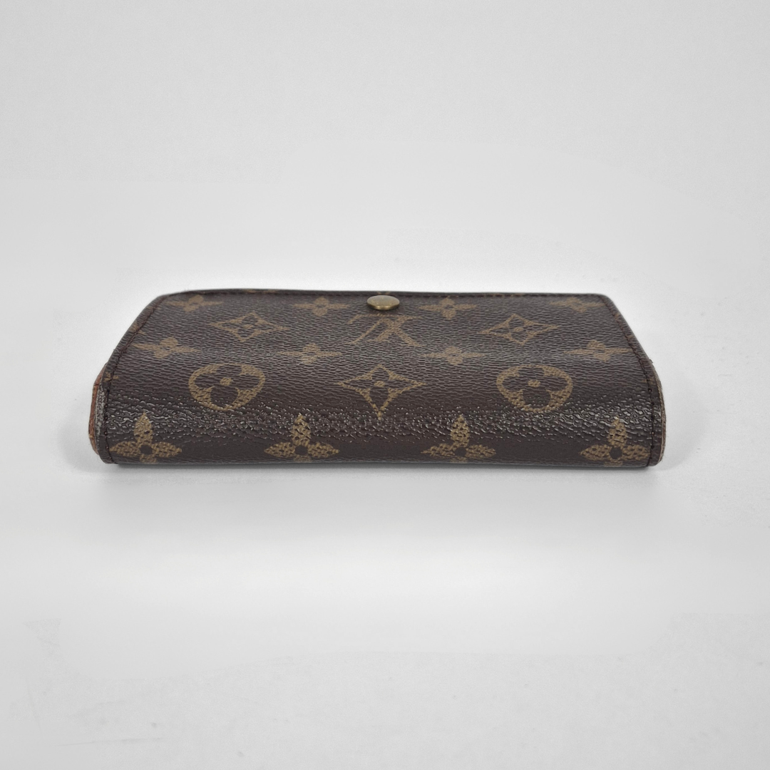 Brown leather wallet with brand logo on a light gray background