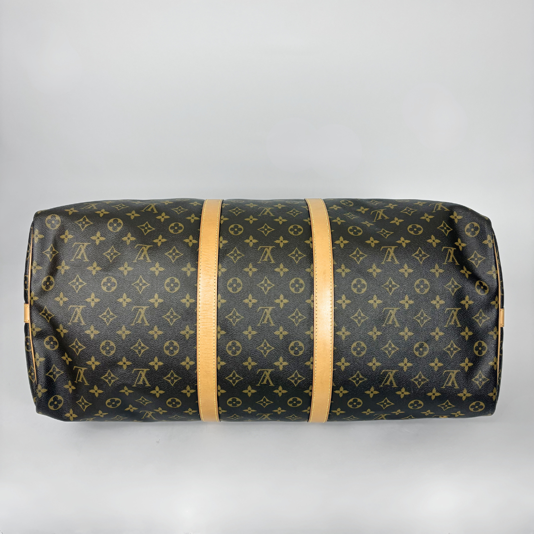 Louis Vuitton duffel bag with monogram pattern on a light gray background