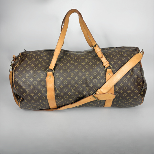 Louis Vuitton duffel bag with monogram pattern on a light gray background
