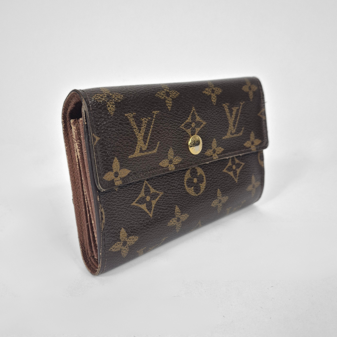 Louis Vuitton wallet with monogram pattern on a white background