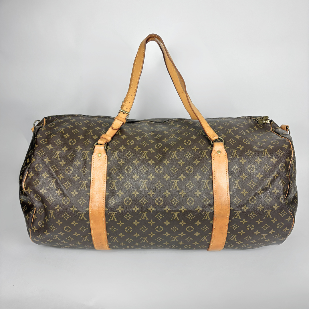 Louis Vuitton duffel bag with monogram pattern on a light gray background