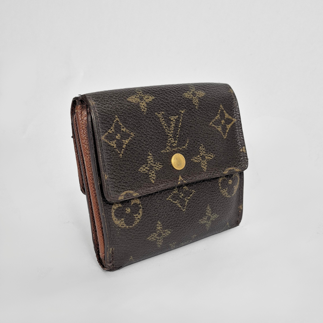 Louis Vuitton wallet with monogram pattern on a light gray background
