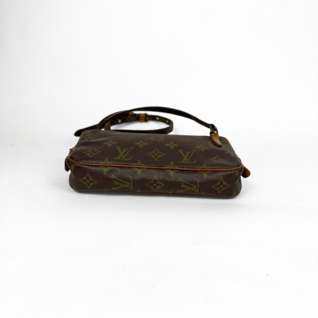 Brown handbag with monogram pattern on a white background