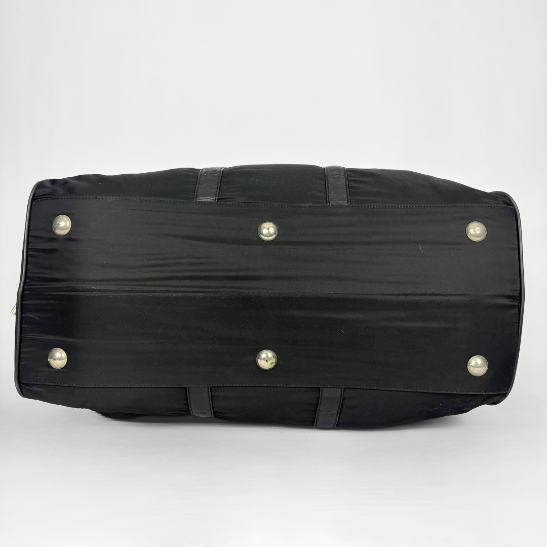 Black backpack with a strap and lock on a white background