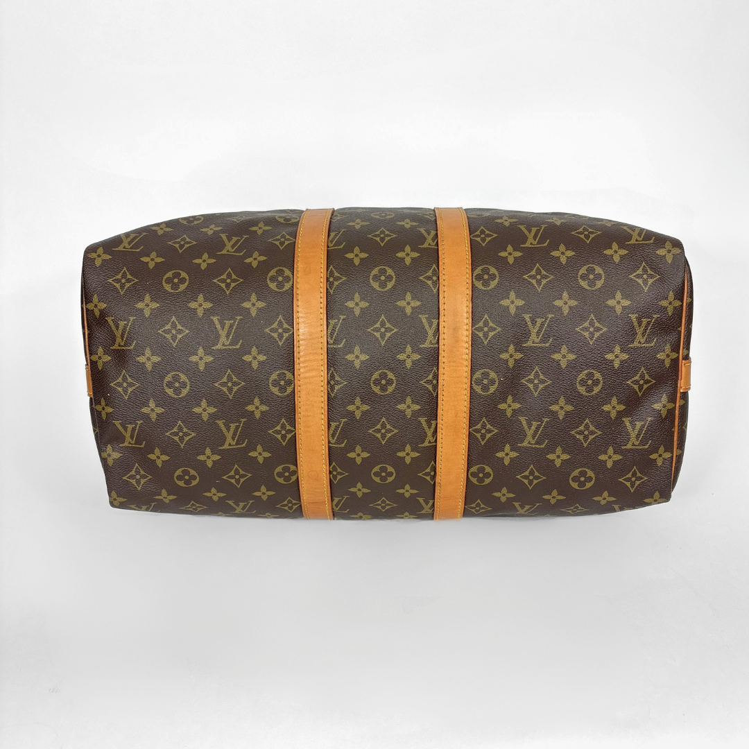 Louis Vuitton monogram handbag with brown strap on a white background
