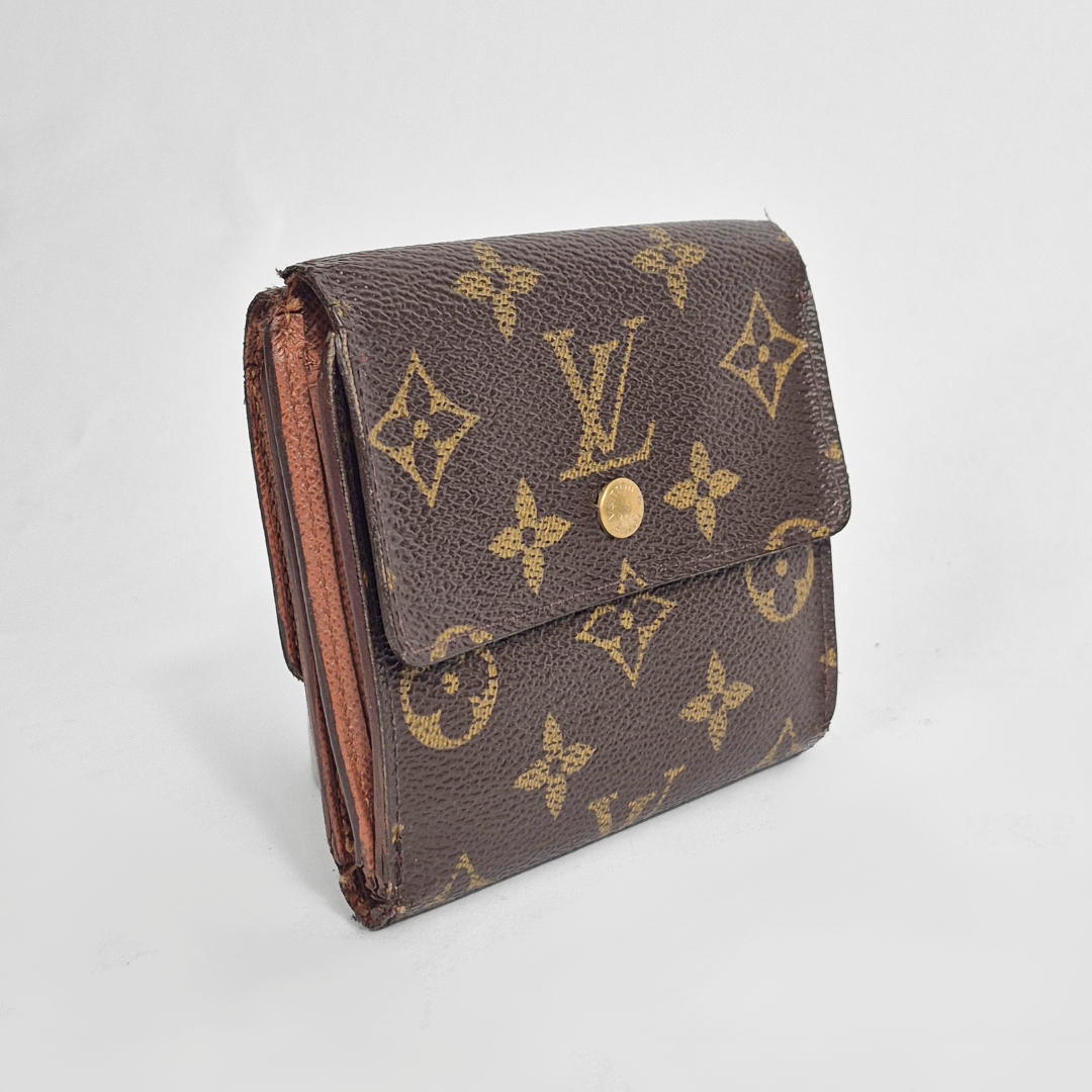 Louis Vuitton wallet with monogram pattern on a light gray background
