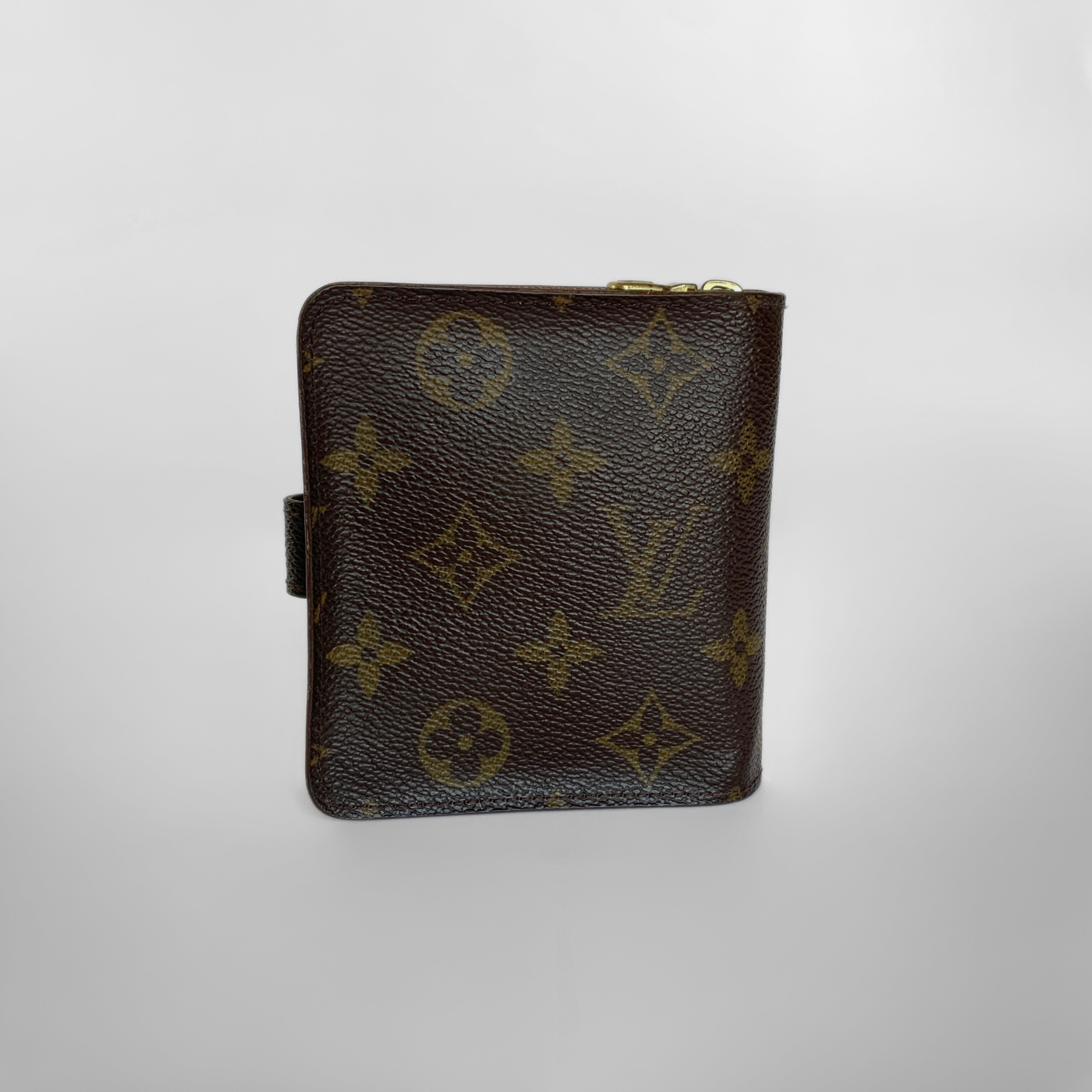 Brown leather wallet with monogram pattern on a light gray background