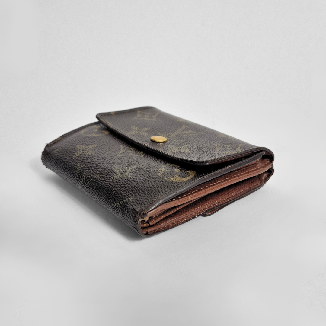 Folded brown leather wallet with a pattern on a light gray background