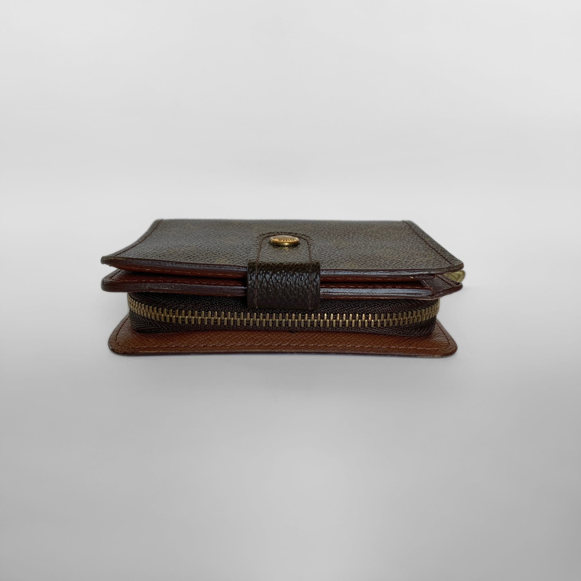 Two-tone leather wallet with zipper on a light gray background