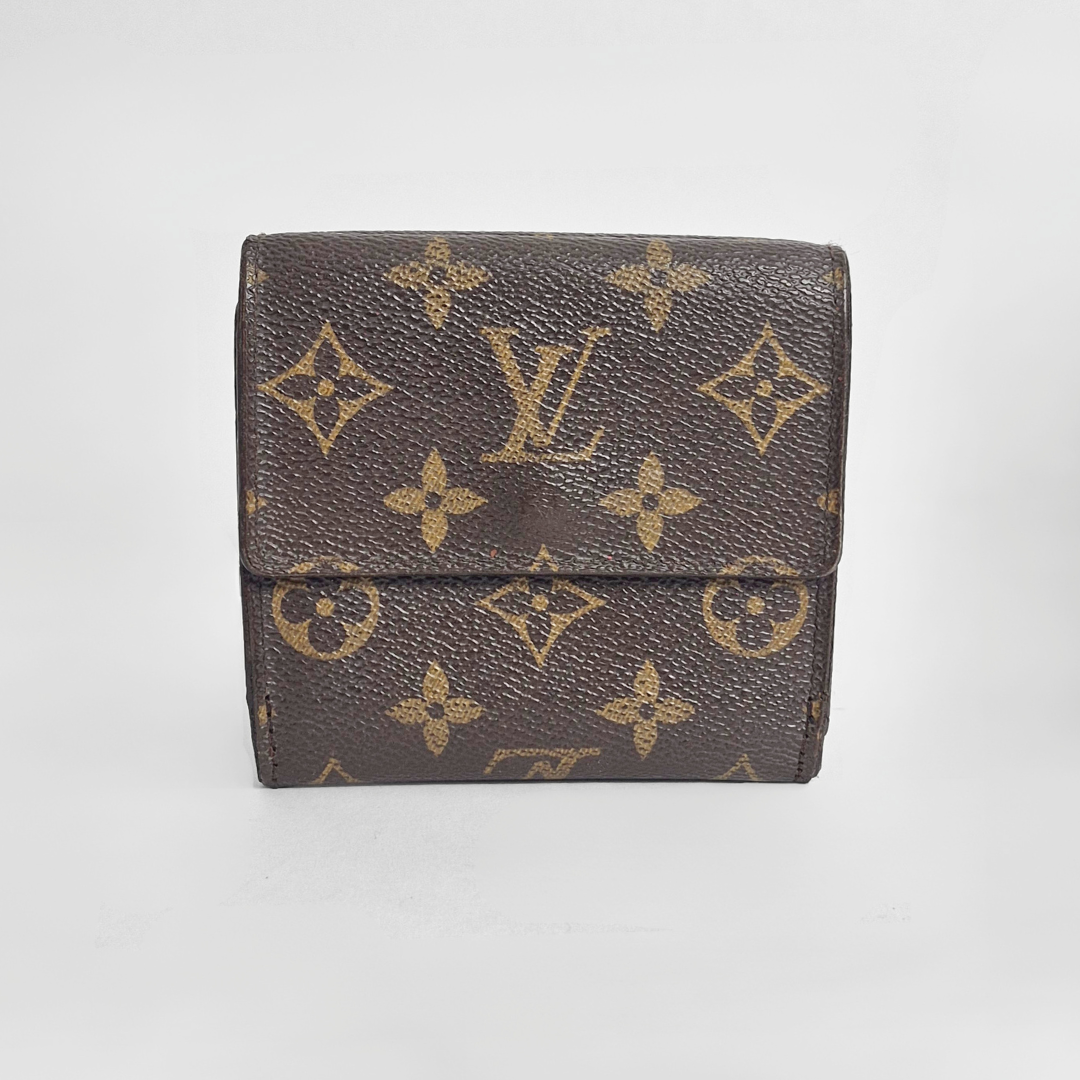 Louis Vuitton wallet with monogram pattern on a light gray background