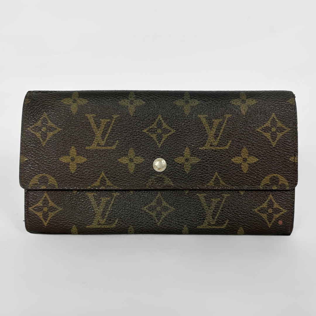 Louis Vuitton wallet with monogram pattern on a white background