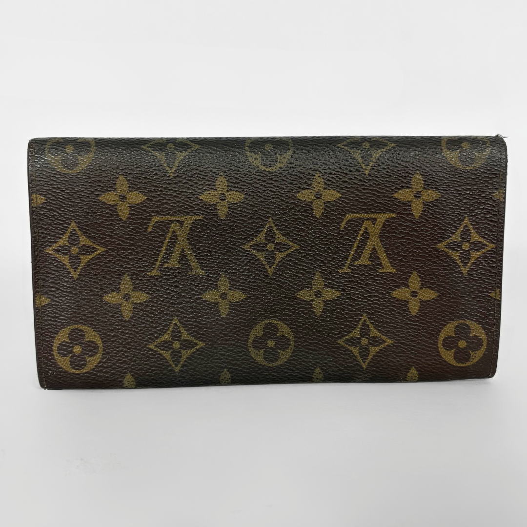Louis Vuitton wallet with monogram pattern on a white background