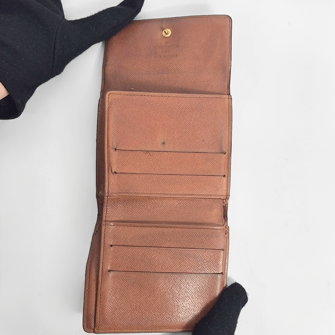 Brown leather wallet with visible stitching on a white background