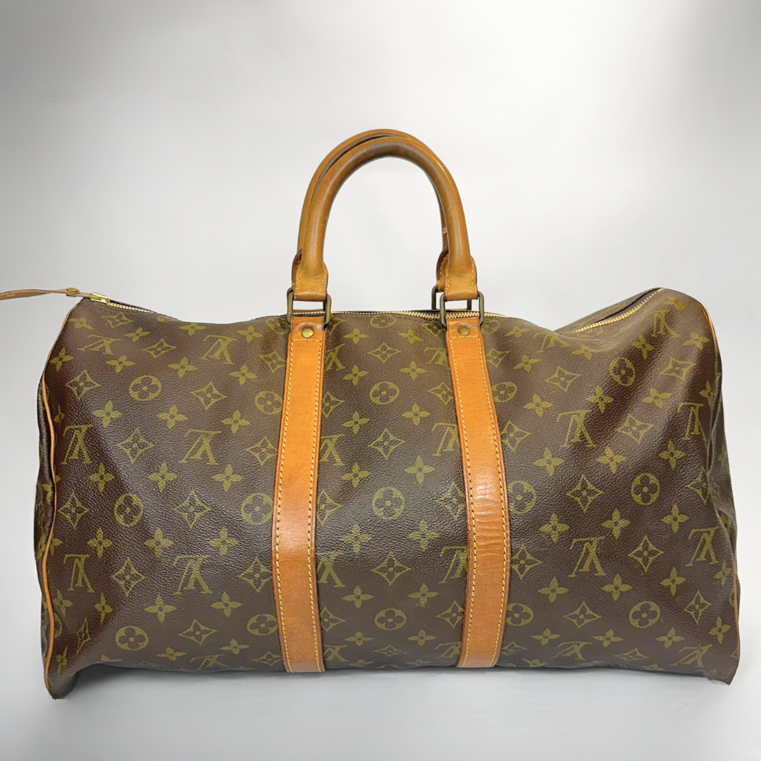 Brown travel bag with tan handles and straps on a white background