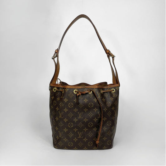 A Louis Vuitton monogram canvas bucket bag with brown leather trim and shoulder strap, shown against a light gray background.