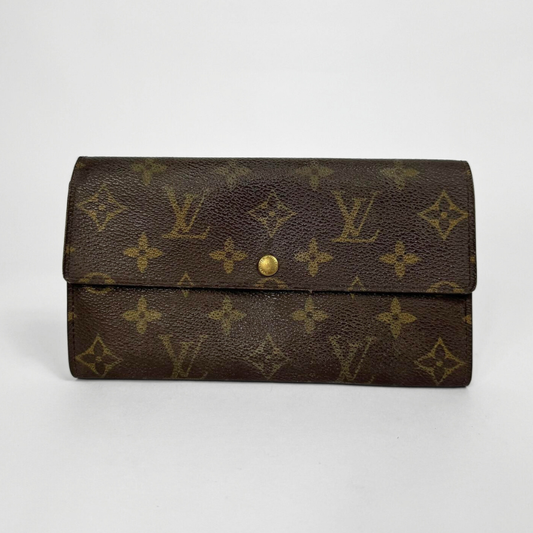 Brown wallet with gold monogram pattern on a white background