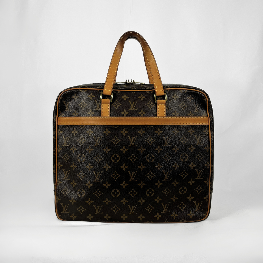 Louis Vuitton monogram canvas duffel bag with tan leather handles and trim, photographed against a plain white studio background.