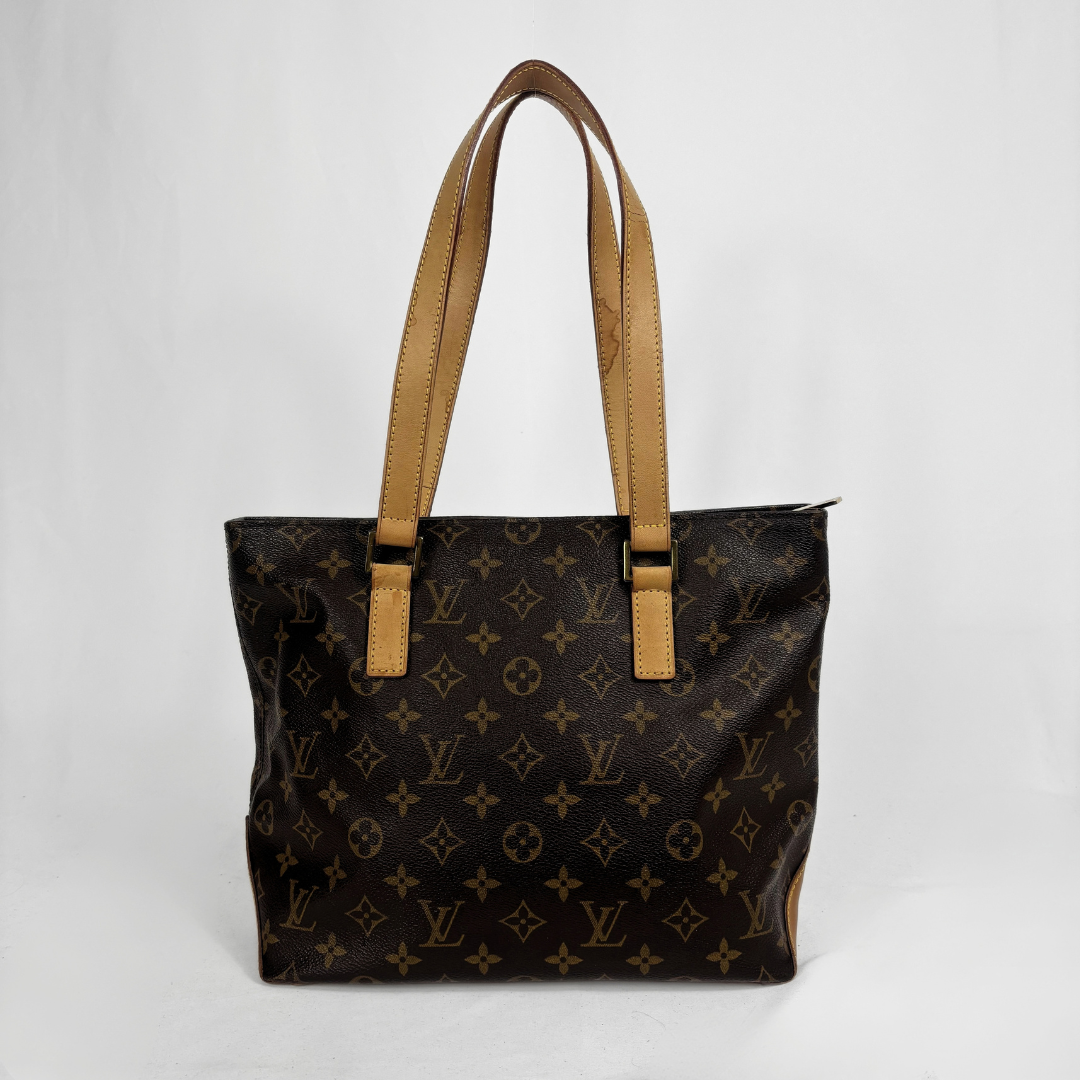 A Louis Vuitton monogram canvas tote bag with tan leather shoulder straps, photographed against a plain white background.