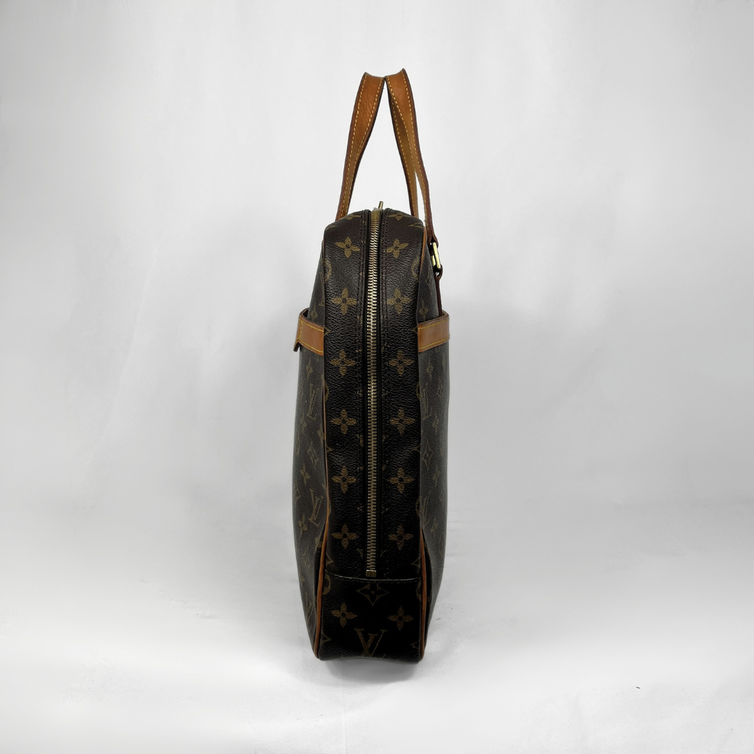 A Louis Vuitton monogram canvas shoulder bag shown from the side profile against a white studio background.