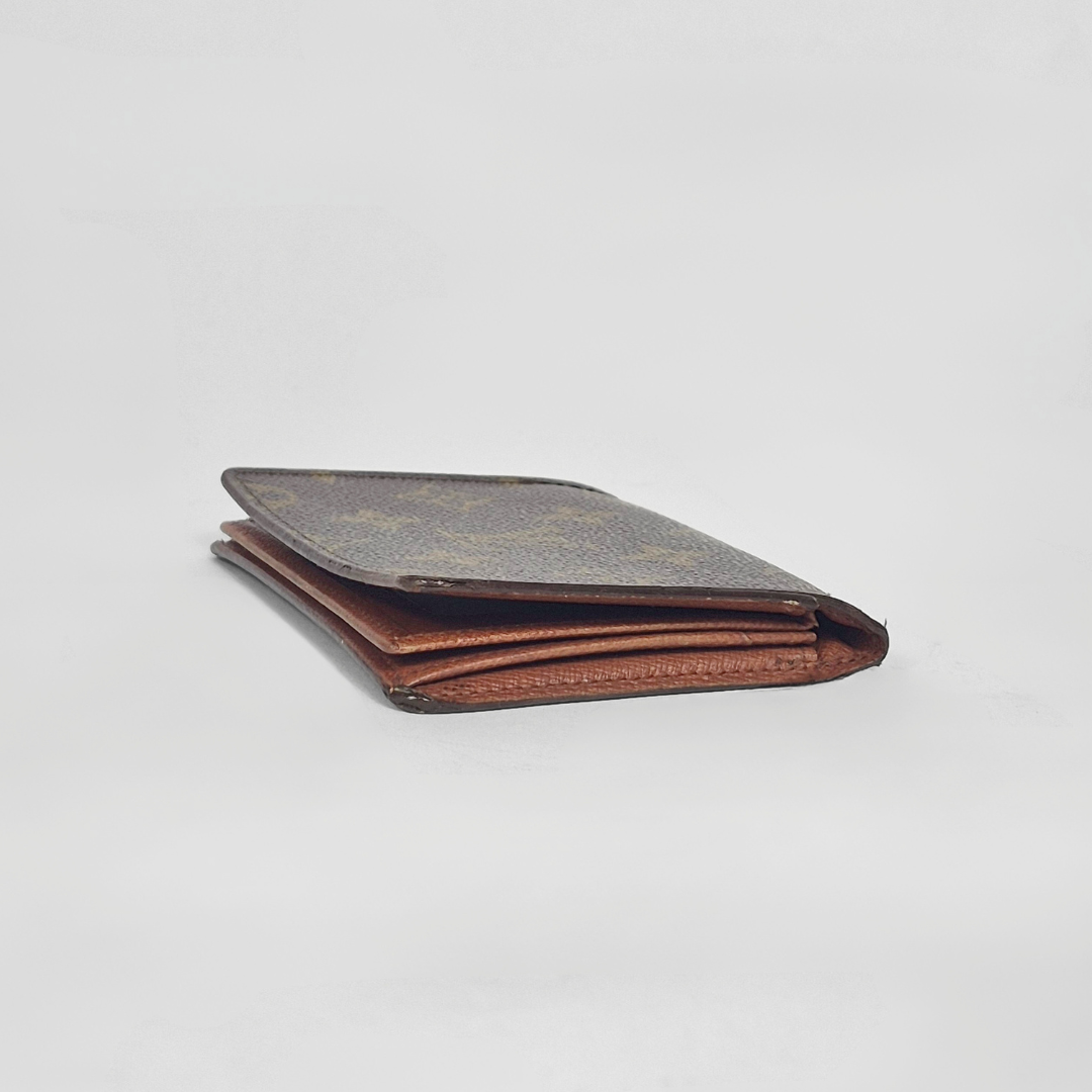 Folded leather wallet on a light gray background