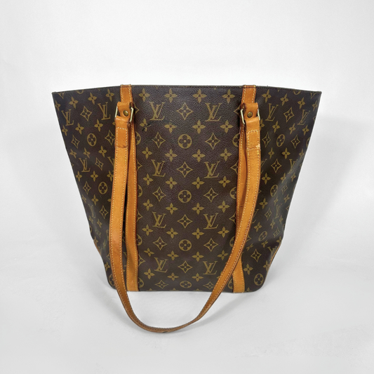 Designer handbag with monogram pattern on a white background