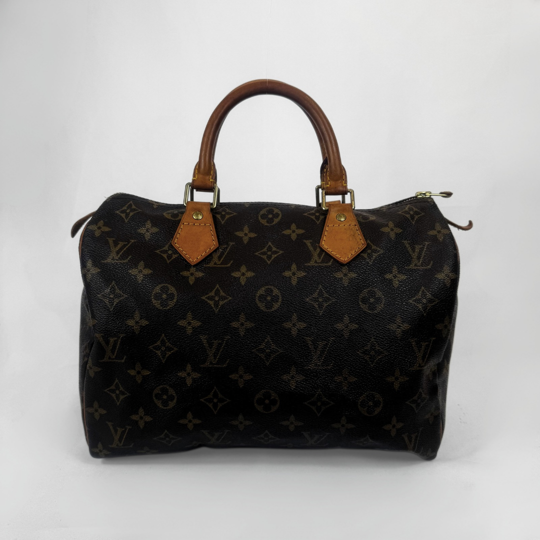 Louis Vuitton monogram canvas Speedy handbag in black with brown leather handles and gold-tone hardware, photographed against a light gray studio background.