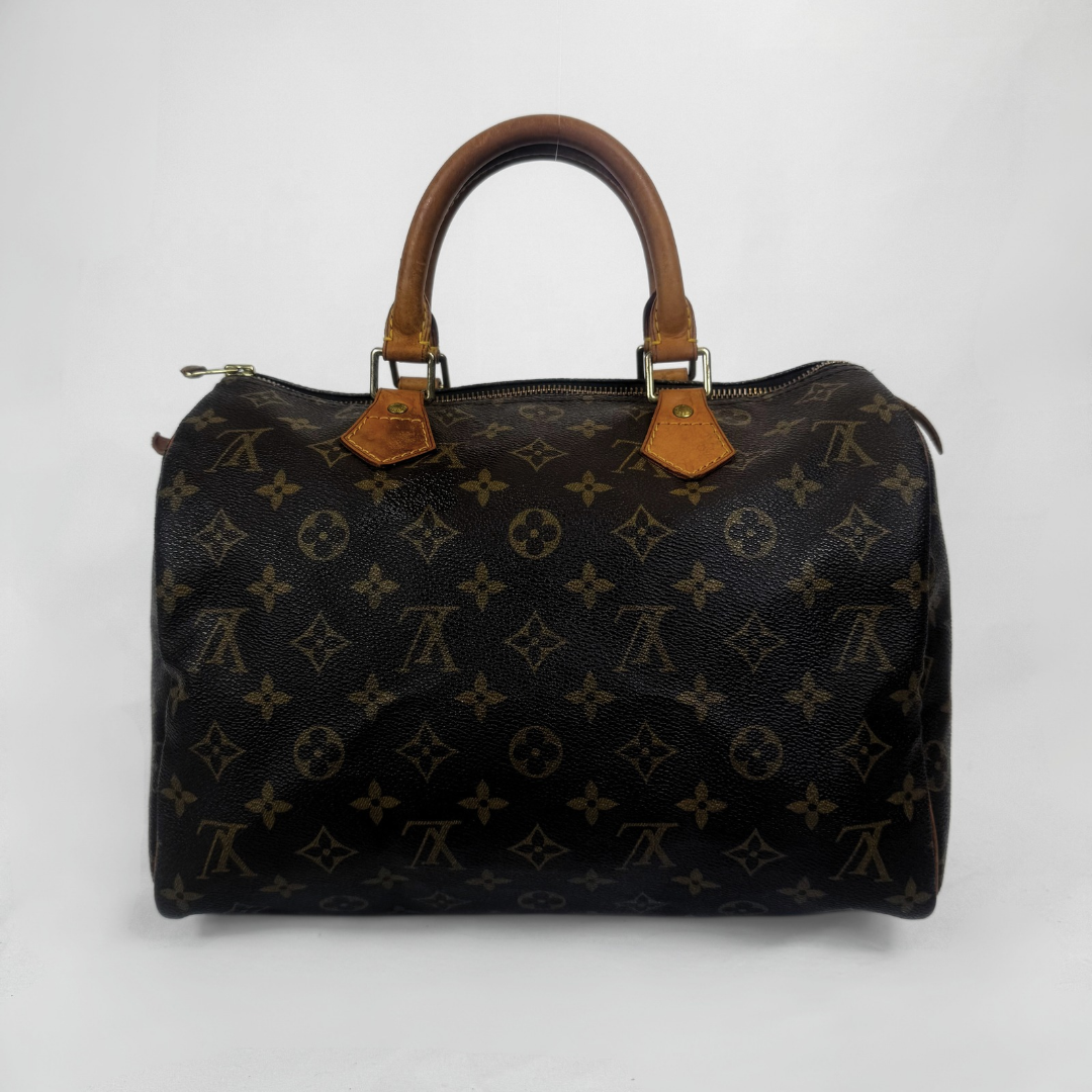 A Louis Vuitton monogram Speedy handbag in dark brown coated canvas with tan leather handles and gold-tone hardware, photographed against a plain light gray background.