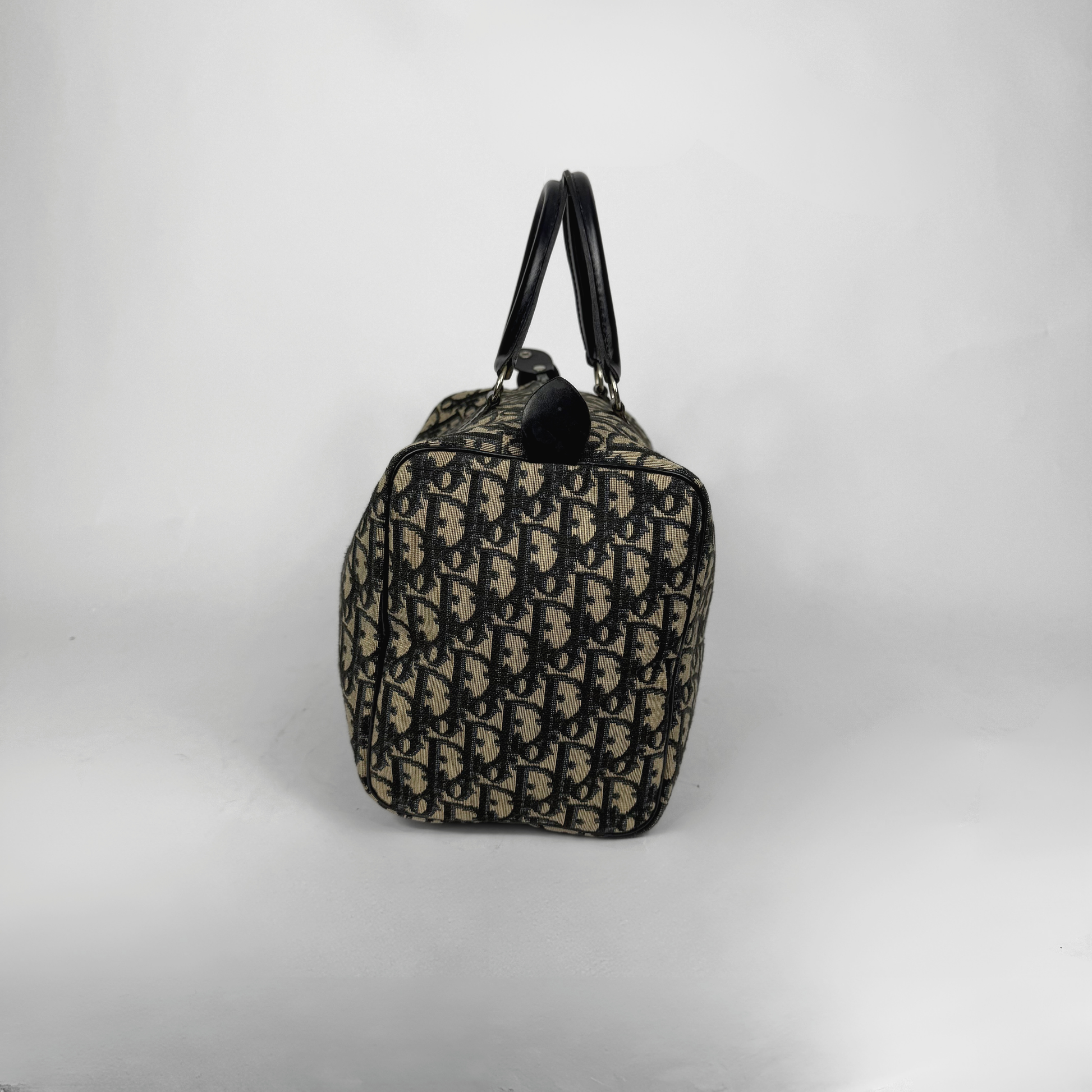 Designer handbag with a distinctive pattern on a light gray background