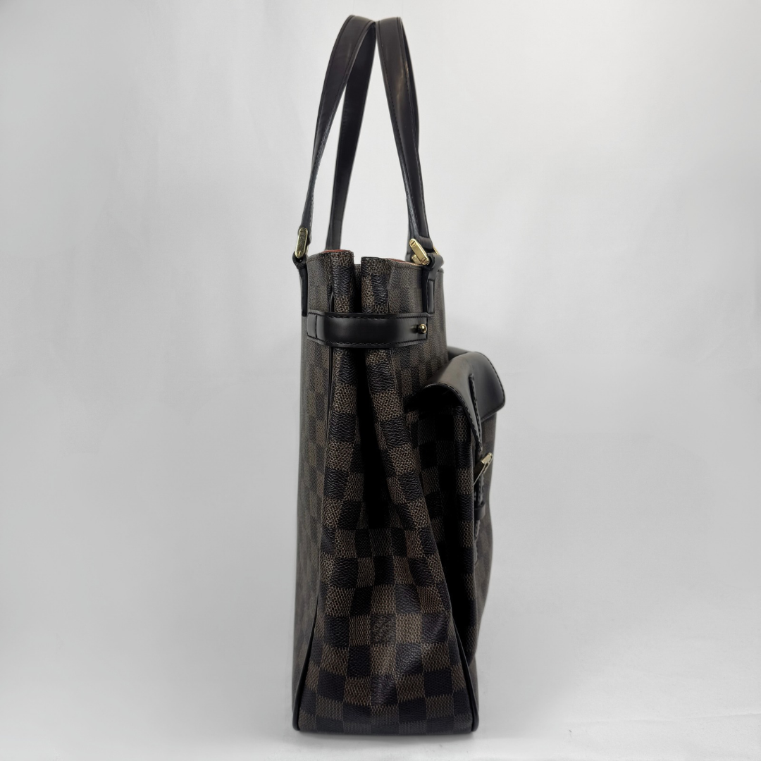 A Louis Vuitton shoulder bag in Damier Ebene canvas, shown from a side profile view against a light gray background.