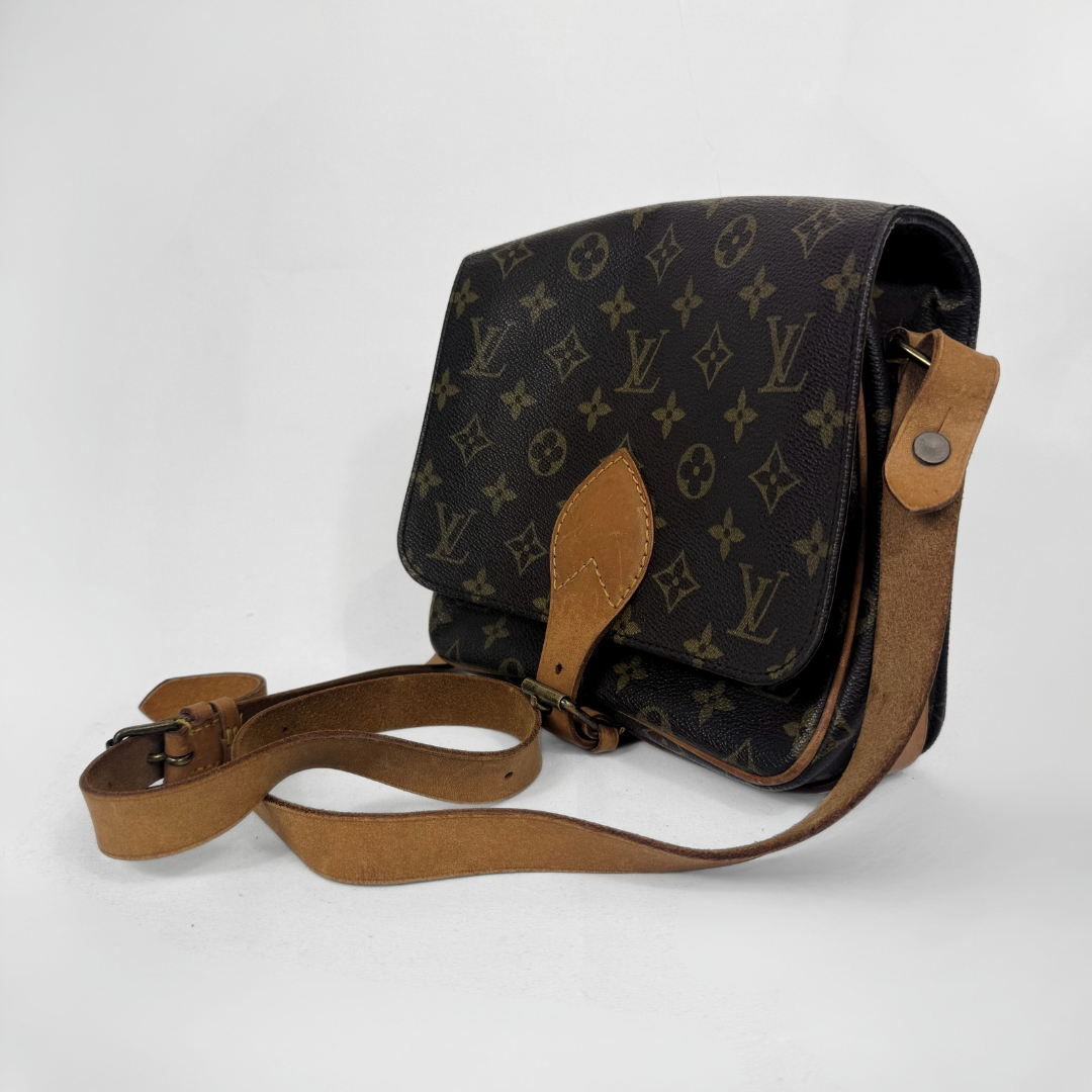 Louis Vuitton Monogram canvas messenger bag with tan leather trim and a matching shoulder strap, photographed on a light gray background.