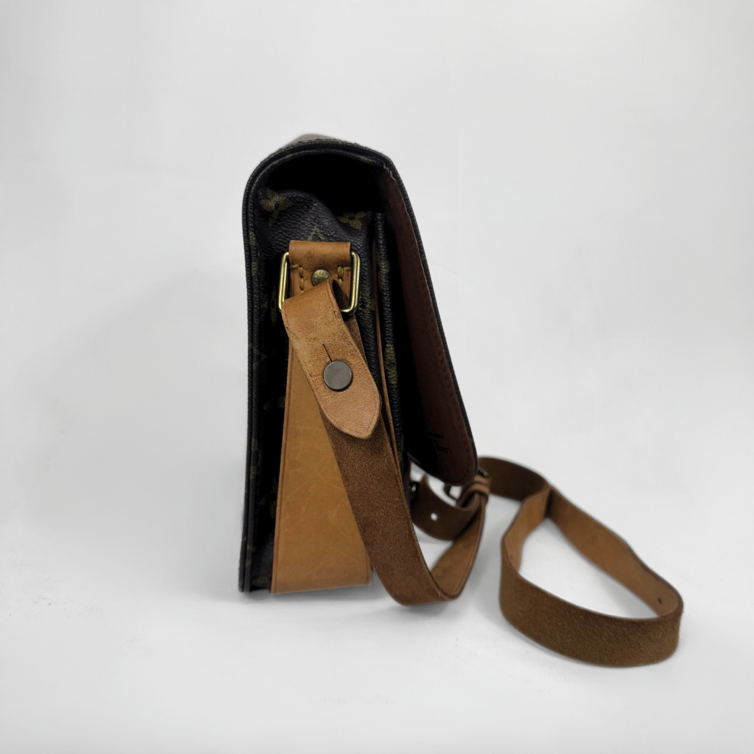 A vintage Louis Vuitton shoulder bag in brown monogram canvas with tan leather trim and strap, shown from a side profile view on a white background.