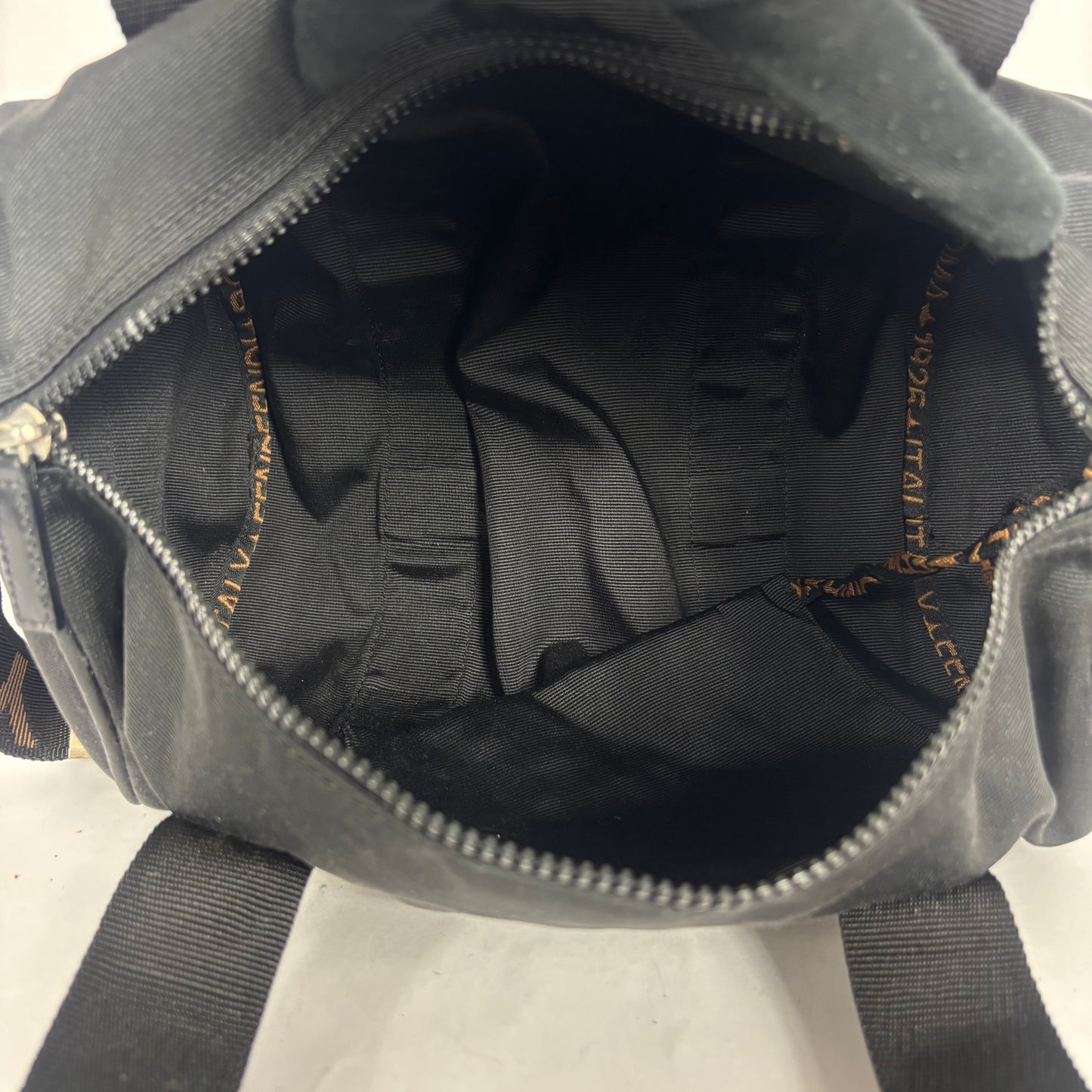Black duffel bag with 'FENDI' logo on a white background: INSIDE