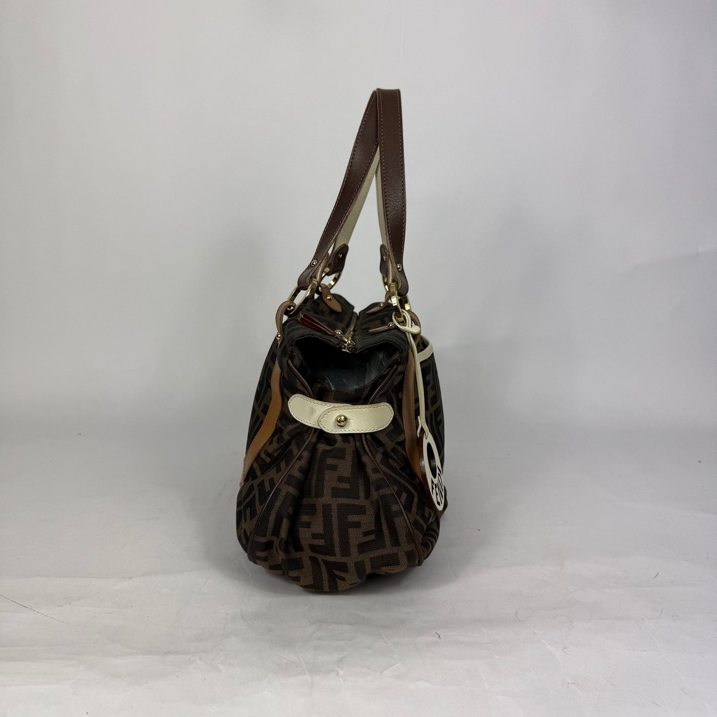 Fendi Zucca monogram canvas shoulder bag with letaher trim and a large white cicular FENDI charm.