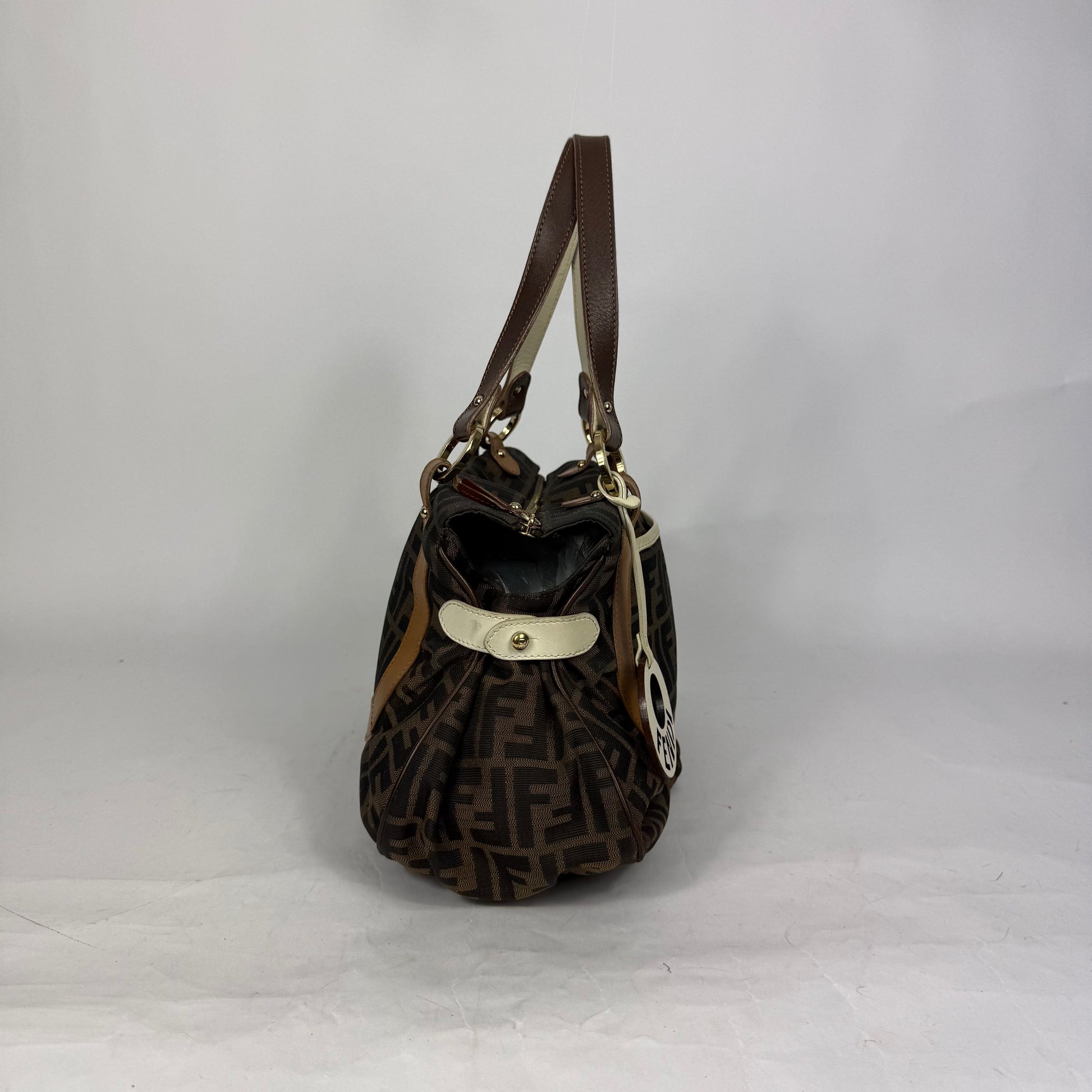 Fendi Zucca monogram canvas shoulder bag with letaher trim and a large white cicular FENDI charm.