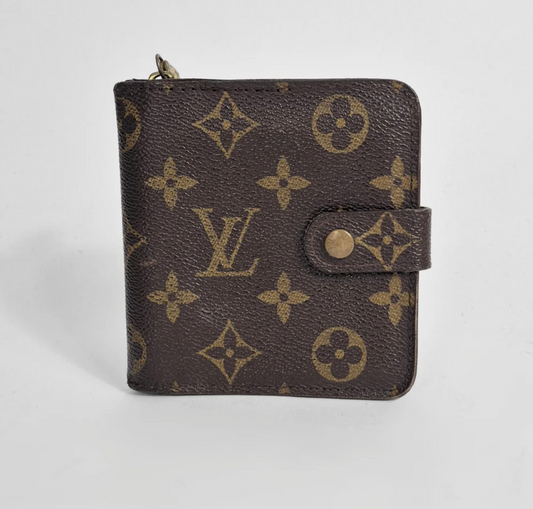 Louis Vuitton wallet with monogram pattern on a white background